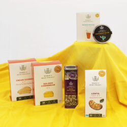 Women's Bean Project Weekender gift box set laid out on a yellow table cloth highlighting the various mixes in the box.