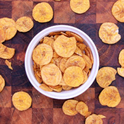 Women's Bean Project Chili picante plantain chips in a dish on the table.