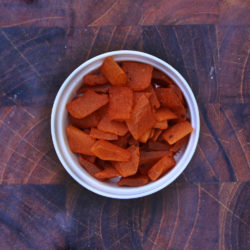 Women's Bean Project Chili Spiced Mango in a bowl on a wooden table.